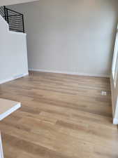 Unfurnished room with light wood-type flooring