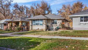 Bungalow-style house featuring a front lawn