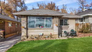 View of front of home with a patio area and a front yard