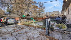 View of yard featuring a mountain view and a playground