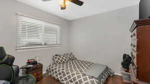 Bedroom with ceiling fan and dark hardwood / wood-style flooring