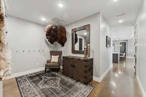 Living area featuring hardwood / wood-style flooring and an inviting chandelier