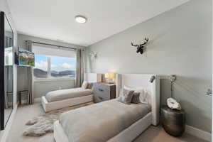 Bedroom featuring light colored carpet