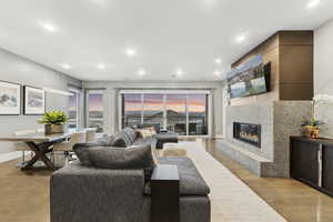 Living room with a premium fireplace and light hardwood / wood-style floors