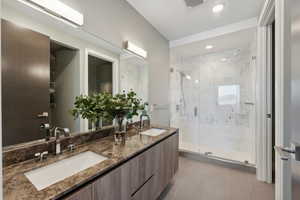 Bathroom with vanity, tile patterned floors, and a shower with shower door