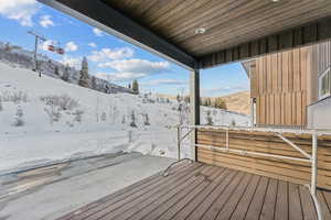 Snow covered deck with a mountain view