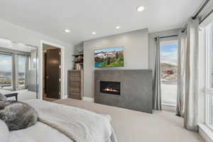 Bedroom featuring light carpet