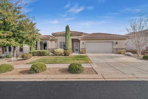 Mediterranean / spanish-style home featuring a garage