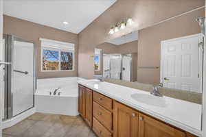 Bathroom featuring separate shower and tub, tile patterned flooring, and vanity