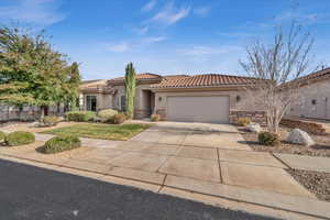 Mediterranean / spanish house featuring a garage