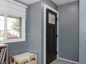 Carpeted foyer entrance with a textured ceiling