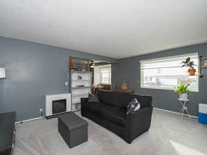 Living room with ceiling fan and carpet