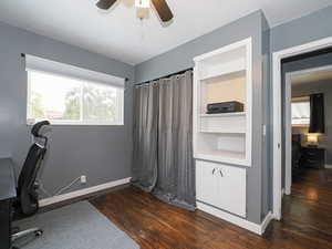 Office area featuring ceiling fan and dark wood-type flooring