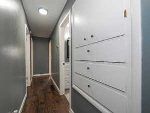 Corridor with dark hardwood / wood-style flooring