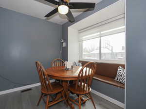 Dining space featuring ceiling fan and hardwood / wood-style flooring