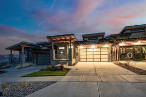 View of front of property featuring stone siding and driveway