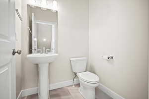 Bathroom featuring tile patterned flooring and toilet