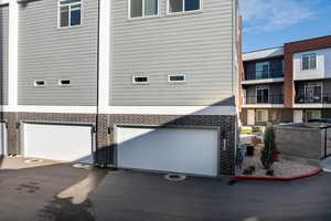 View of home's exterior featuring central AC and a garage