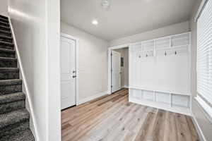 Mudroom with light hardwood / wood-style flooring