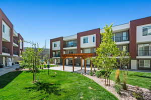 Surrounding community with a pergola and a lawn