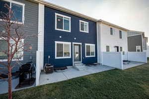 Rear view of property with a yard, a patio area, and central air condition unit