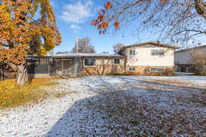 Rear view of property with screened in porch