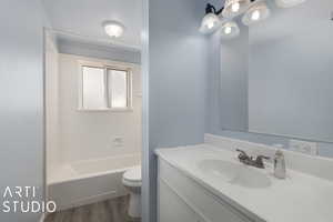 Full bathroom featuring washtub / shower combination, toilet, vanity