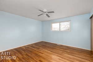 Bedroom with hard wood flooring