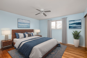 Bedroom with ceiling fan and hardwood / wood-style flooring