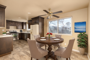 Dining space featuring light wood-type flooring, ceiling fan, and sink