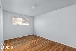 Spare room featuring hardwood flooring