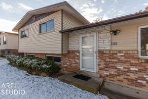 View of snow covered property entrance