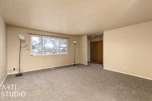 Spare room featuring carpet flooring