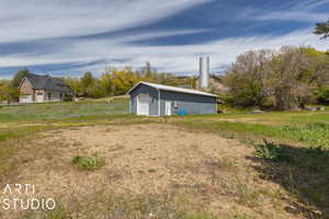 View of yard featuring a garage and an outdoor structure