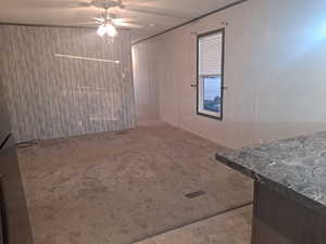 Living room featuring carpet floors and ceiling fan