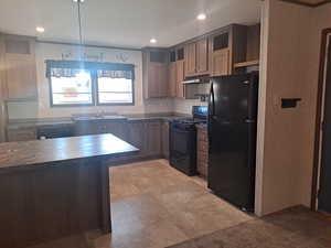 Kitchen with pendant lighting, sink, and black appliances