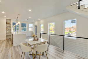 Dining area with light wood-type flooring and sink