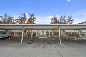 View of parking with a carport