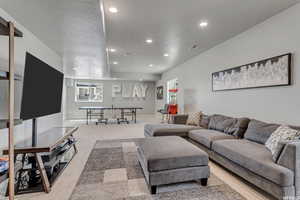 Carpeted living room featuring a textured ceiling