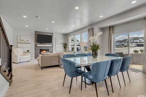 Dining space with a fireplace and a textured ceiling