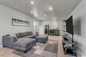 Carpeted living room with a textured ceiling