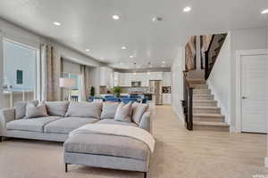 Living room with light hardwood / wood-style floors and a textured ceiling