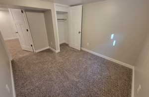 Unfurnished bedroom with carpet floors and a closet