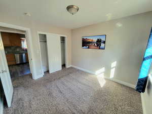 Unfurnished bedroom with a closet and carpet floors