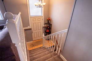 Entrance foyer with a chandelier and hardwood / wood-style floors