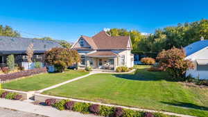 View of front facade featuring a front lawn and a porch