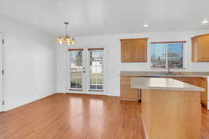 Open kitchen with island and hard floors and eat in dining