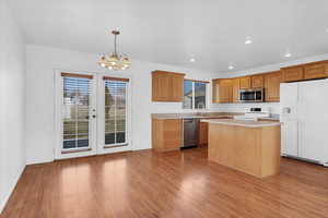 Open kitchen with island and hard floors and eat in dining