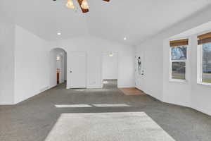 living room featuring carpet flooring, vaulted ceiling fan and natural light