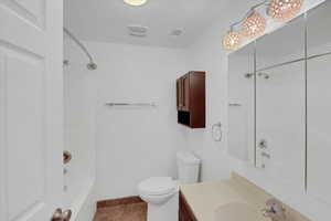 Full bathroom featuring tile patterned floors, vanity, tub / shower combination, and toilet